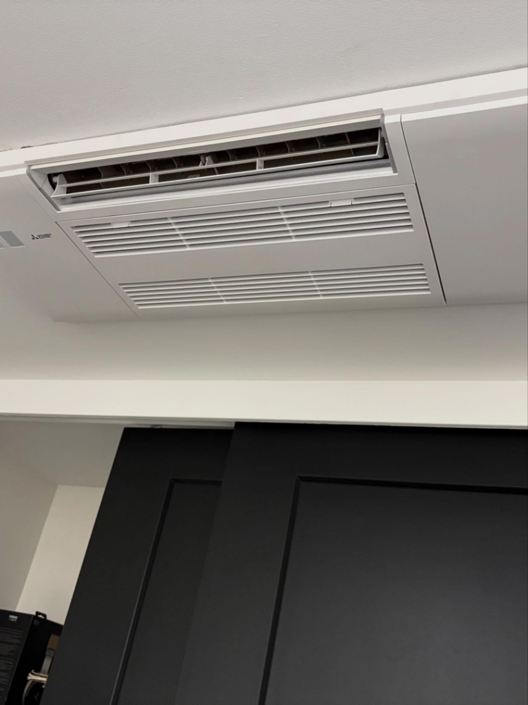 A modern ceiling-mounted HVAC cassette system installed in a white ceiling by Royal Heating & Air LLC in Sparks, NV