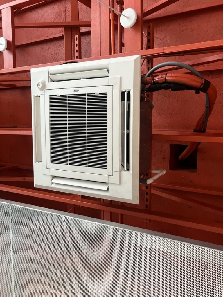 A modern ceiling-mounted mini-split HVAC unit installed in a commercial space by Jons-Air in Carmel, IN.