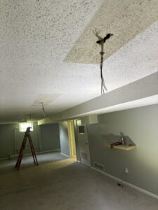 Exposed ceiling wiring for light fixture pre-installation in a room by Amped Electric in Virginia Beach, VA.