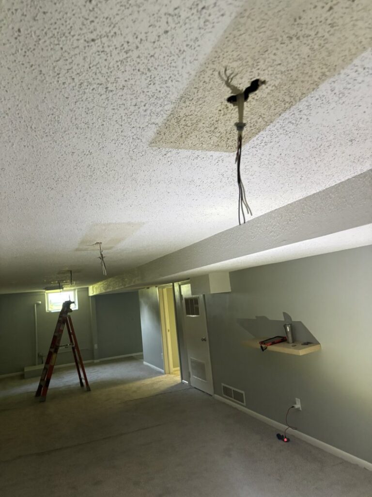 Exposed ceiling wiring for light fixture pre-installation in a room by Amped Electric in Virginia Beach, VA.