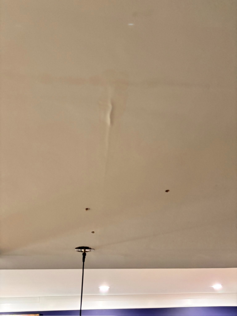 A ceiling showing holes for recessed lighting and a hanging fixture, indicating electrical work by 3 Phase KC in Independence, MO.