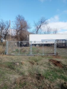 A newly installed chain-link double gate by DB Fencing, LLC in Teague, TX.