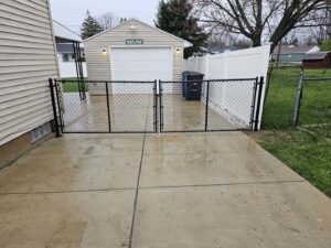 Two black chain link gates installed for a driveway by Barney's Landscaping in Dayton, OH.