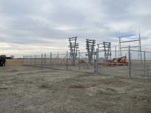 A chain-link fence and gate installation with barbed wire for a commercial site by Big Red Fencing LLC in Waverly, NE.