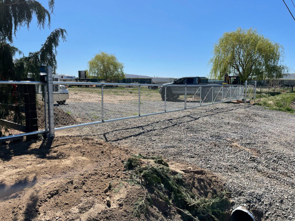 A chain-link fence with a gate installed by Integrity Gates and Fencing in Yakima, WA
