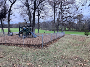 A chain-link fence installed around a playground area by Rice&Family Fencing LLC in Greenfield, TN.