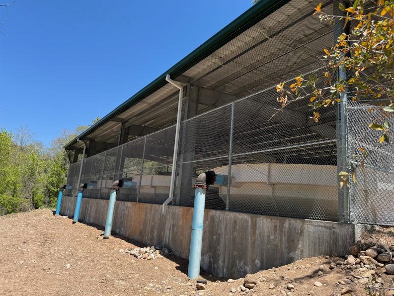 A newly installed chain-link fence enclosing a large structure by SFA Contracting LLC in Tucson, AZ.