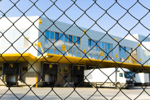 A chain-link fence providing security around a warehouse facility by Palmetto Fence Co in North Charleston, SC.