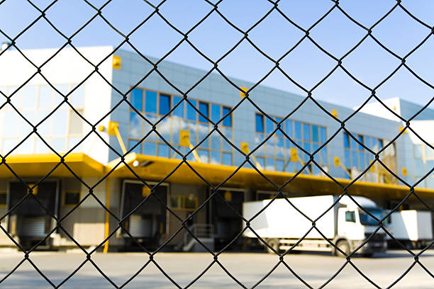 A chain-link fence providing security around a warehouse facility by Palmetto Fence Co in North Charleston, SC.