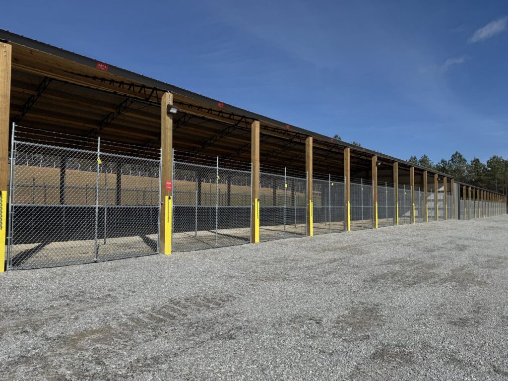 Chain-link fences with barbed wire installed at a storage facility by Creative Fence Designs in Columbus, GA.