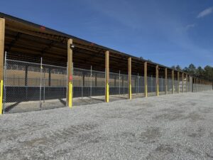 Chain-link fences with barbed wire installed at a storage facility by Creative Fence Designs in Columbus, GA.