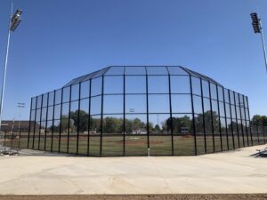 A robust chain-link fence enclosing a baseball field, installed by The Fence Man in Fort Smith, AR.
