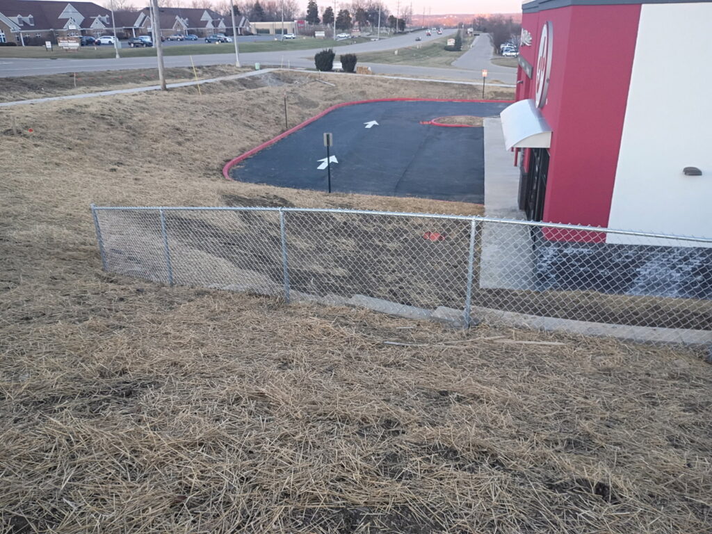 A chain-link fence installed along a commercial property by Affordable Fence Builders in Dayton, OH.