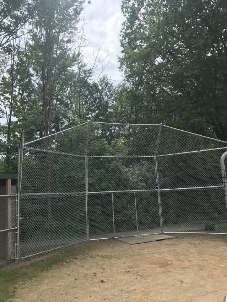 A chain-link fence enclosure, possibly for a sports area, installed by The Fence Dr. in Scranton, PA.