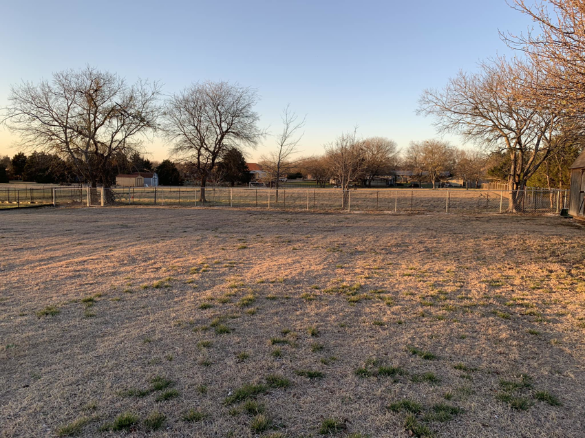 A newly installed chain-link fence enclosing a large grassy area by BAR Z Fencing and Welding LLC in Midlothian, TX
