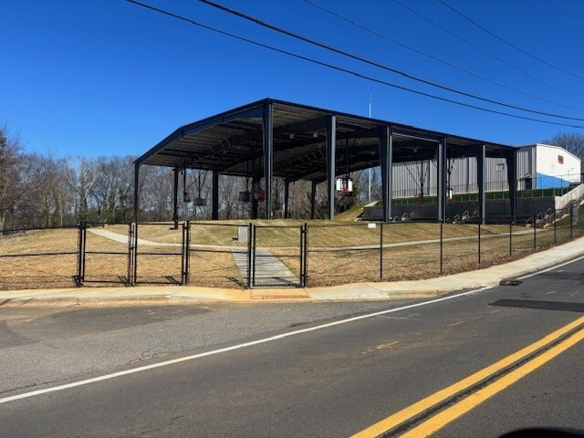 A newly installed chain-link fence with a gate surrounding a facility by First Fence of Georgia in Kennesaw, GA.