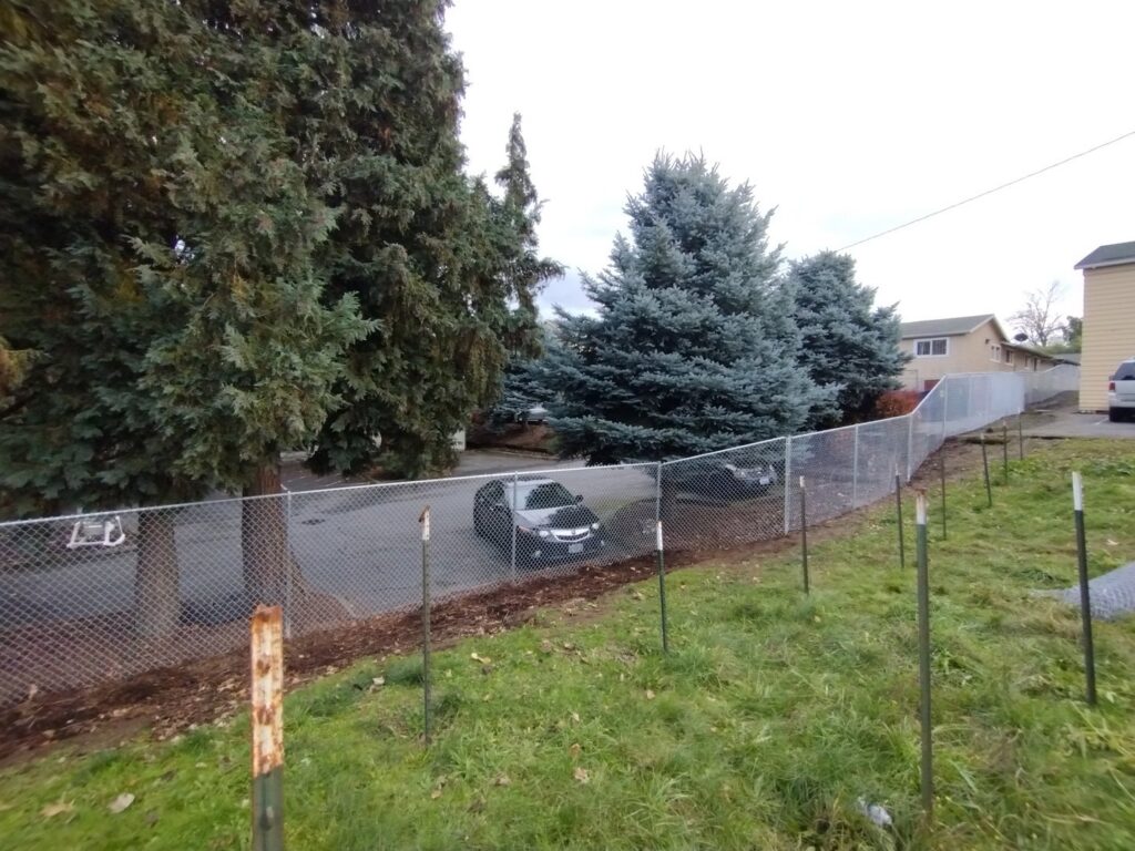 Chain-link fence installation in progress by Stewart & Son Gate & Fence Co. in Hillsboro, OR