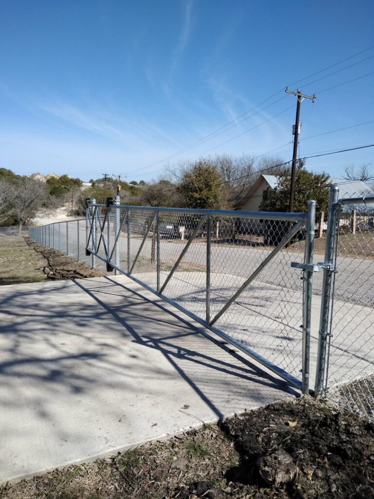A durable chain link fence with a wide access gate installed by City Fence Co of San Antonio, TX