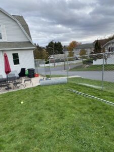 Chain-link fence materials and posts on the ground, indicating an installation by The Fence Dr. in Scranton, PA.