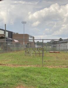 A chain link fence enclosing an open field, providing security and demarcation by National Fence Services, LLC in Macon, GA.