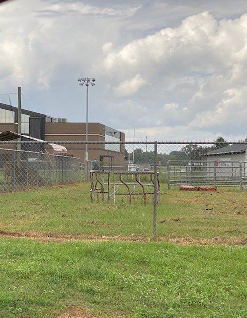 A chain link fence enclosing an open field, providing security and demarcation by National Fence Services, LLC in Macon, GA.