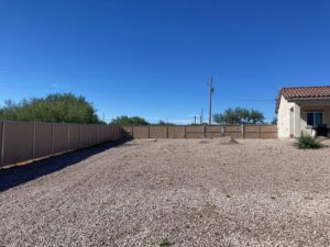 A long chain-link fence with privacy slats installed around a property by SFA Contracting LLC in Tucson, AZ.
