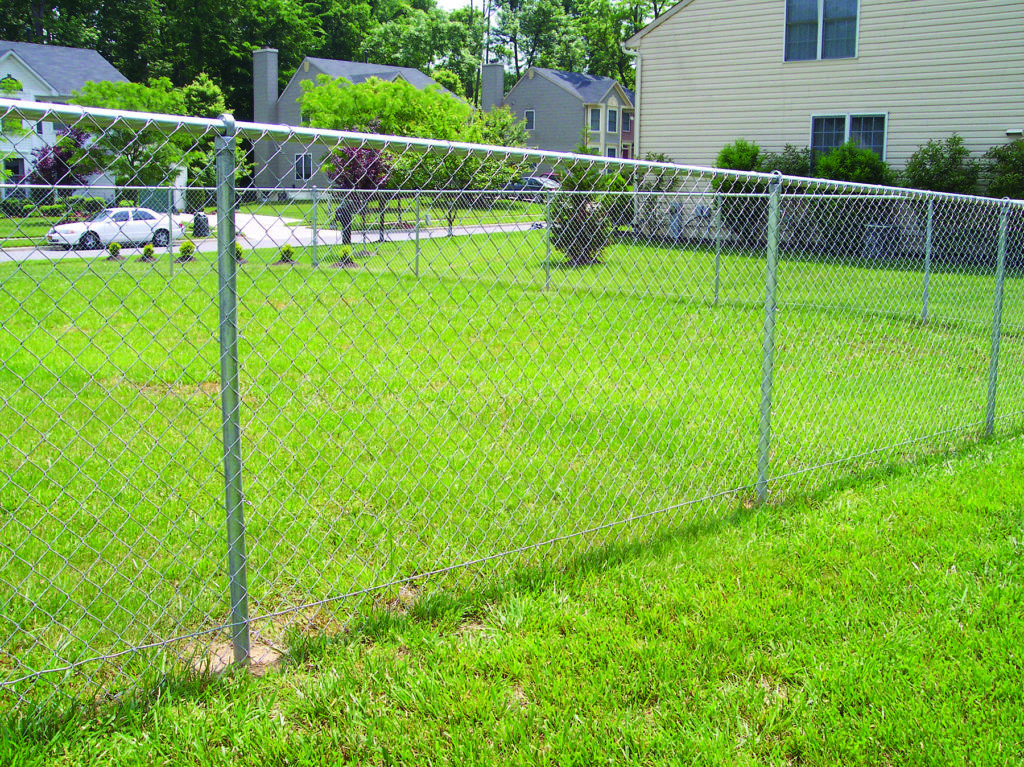 A chain-link fence installed in a residential backyard by Crompton Fence Company in Charleston, SC.
