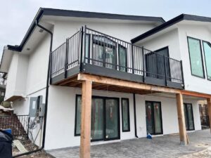 A chain link fence enclosure installed under a deck for storage or security by Supreme Fencing Denver, CO.