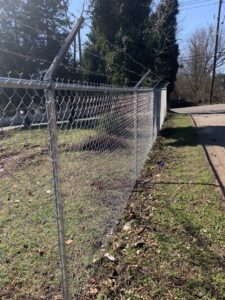 A commercial chain-link fence with barbed wire installed by Escamilla Fence Co. in Knoxville, TN
