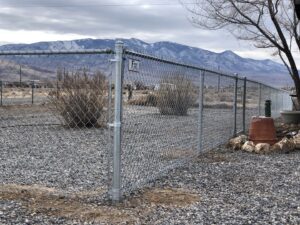 A durable chain-link fence with a secure gate installed in a rural setting by Finest Fence in Simi Valley, CA.