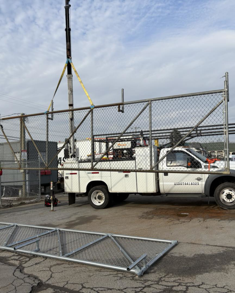 A large chain-link gate being installed with a crane by Gilliam Services LLC in Johnson City, TN.