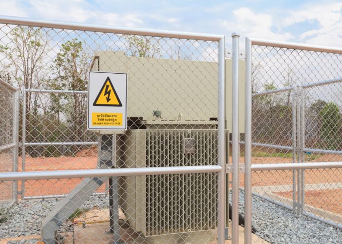 A chain link security fence around an electrical area, installed by Fence Company of Rhode Island in Providence, RI.