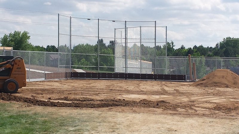 Chain-link fencing under construction around a sports field, a project by Life Time Fence, Inc. in Cedar Rapids, IA.