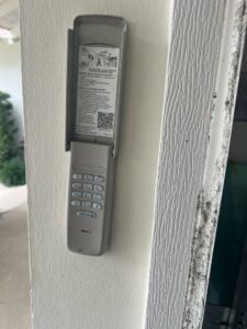 A Chamberlain garage door keypad mounted on a wall, showcasing an installation by BSD Garage Door Service in Naperville, IL.