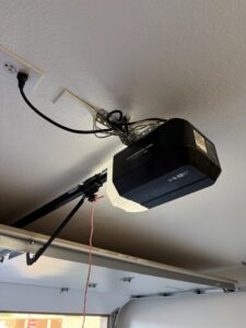 A Chamberlain garage door opener professionally installed on a ceiling by Calavera Garage Doors in Mesa, AZ