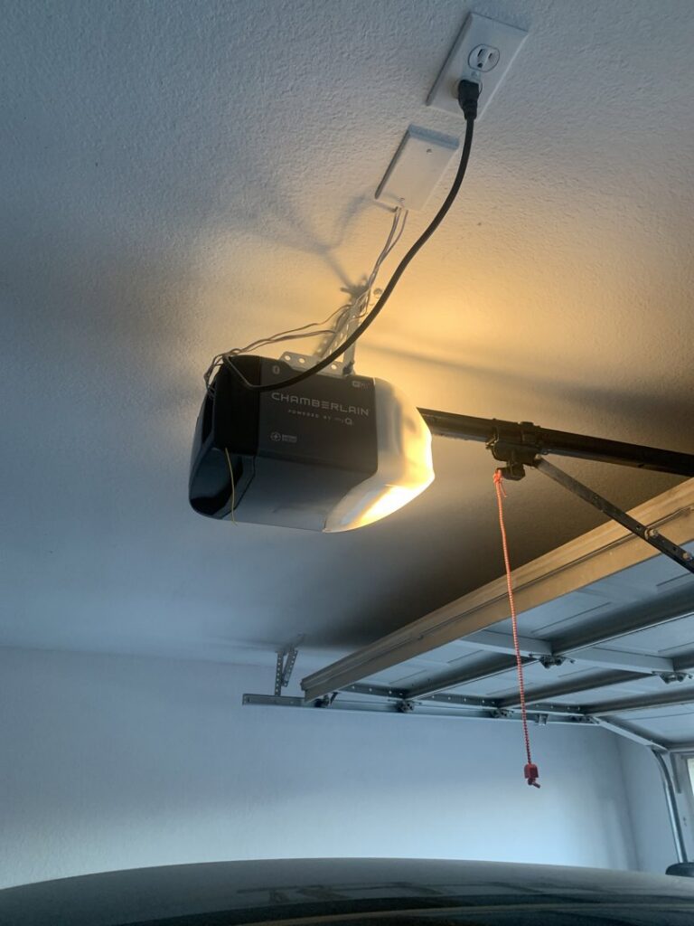A newly installed Chamberlain garage door opener on a ceiling by Team Garage Doors in Mesa, AZ.
