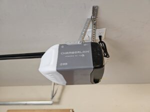 A Chamberlain garage door opener installed on a garage ceiling by Total Door Solutions in Yukon, OK