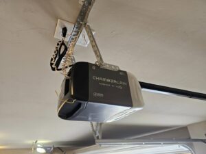 A Chamberlain garage door opener unit installed on a garage ceiling by Total Door Solutions in Yukon, OK