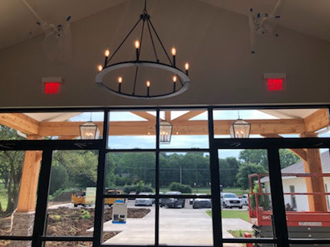 Chandelier and exit sign installation in a commercial building by Empower Electric, LLC in Nashville, TN.