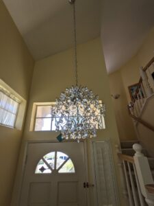 A beautiful chandelier installed in an entryway, showcasing lighting fixture services by Primo's Electrical Services in San Diego, CA.