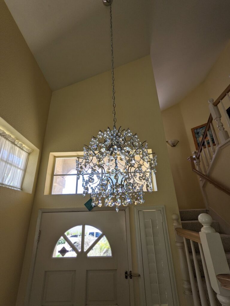 A beautiful chandelier installed in an entryway, showcasing lighting fixture services by Primo's Electrical Services in San Diego, CA.