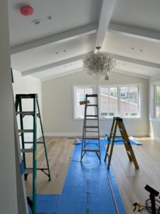 A large chandelier being installed in a room under construction by Gilmore Electrical in Saint Louis, MO