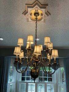 A beautifully installed chandelier hanging from a ceiling, showcasing lighting expertise by Innovate Electric in Earth City, MO.