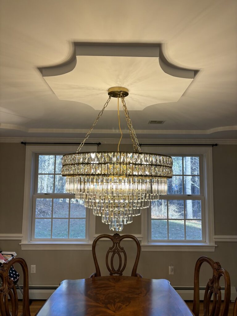 A beautiful chandelier installation in a dining room by Kevin Kelley Electrical Inc in Leominster, MA.