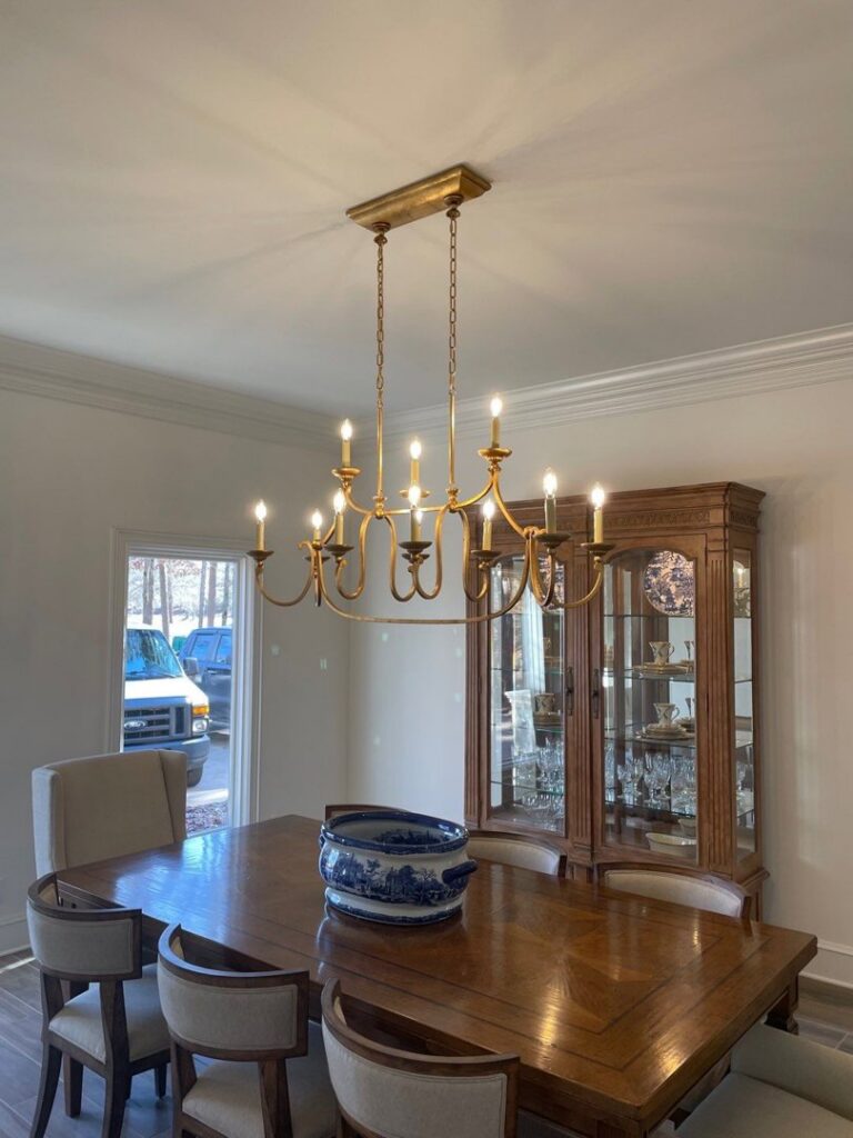 A beautiful chandelier expertly installed over a dining table by McCurley Electric in Little Rock, AR.