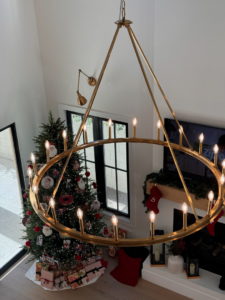 A large brass chandelier with many bulbs hanging in a home, representing electrical fixture installation by Retro Electric AZ in Higley, AZ.