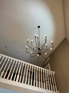 Chandelier installation in a home with high ceilings by TruVolt Electric in South Bend, IN