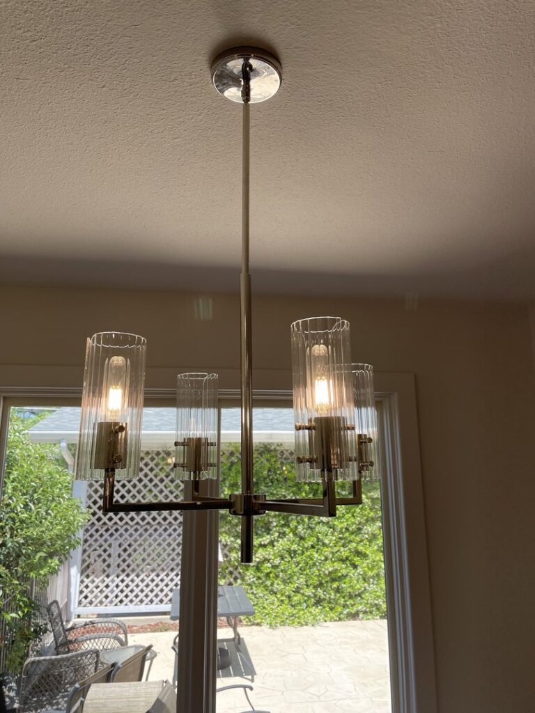 A stylish chandelier light fixture newly installed in a home by Outlaw Home Services, LLC in San Antonio, Tx.