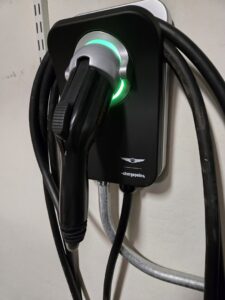 A ChargePoint electric vehicle charger professionally installed with conduit on a wall by Castle Electrical & Lighting in Scottsdale, AZ.