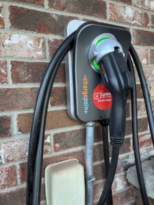 A ChargePoint EV charger installed on a brick wall by Clemens Electric in Averill Park, NY